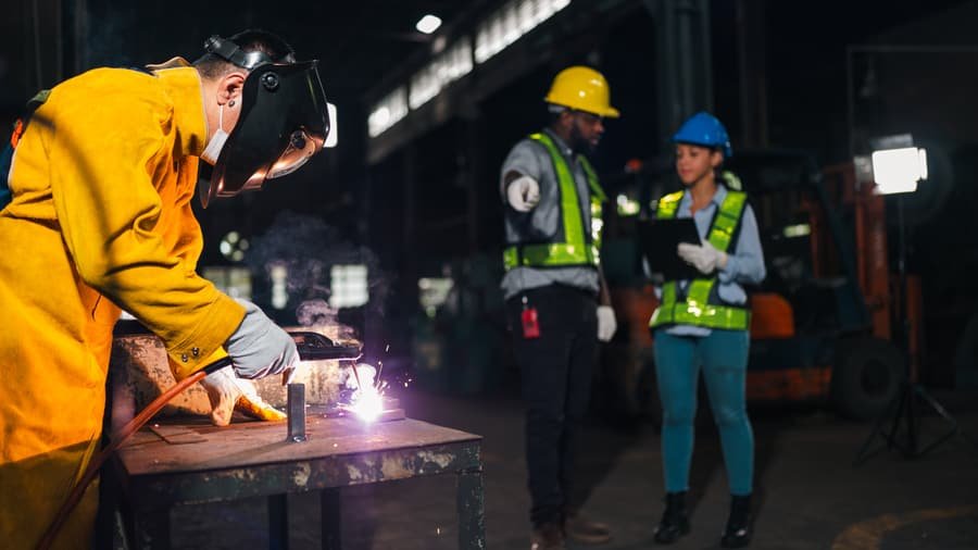 Certified welder working on a structural steel assembly