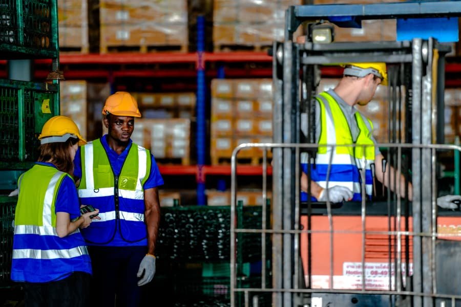 Warehouse operative moving pallets with a forklift